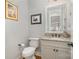 Elegant powder room featuring granite counters, a white vanity, and modern fixtures at 126 Sisters Cove Ct, Mooresville, NC 28117