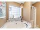 Bathroom featuring a large bathtub, tile accents, and a block window at 134 Cline St, Concord, NC 28027