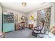 Cozy bedroom featuring a vintage rocking chair, bookshelves and unique decor at 134 Cline St, Concord, NC 28027