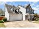 View of the home highlighting the attached two-car garage and complementary siding at 134 Cline St, Concord, NC 28027