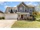 Charming two-story home with a well-manicured lawn and a welcoming red front door at 134 Cline St, Concord, NC 28027