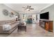 A cozy living room featuring hardwood floors, a ceiling fan, and a large television at 134 Cline St, Concord, NC 28027