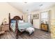 Spacious bedroom features a large bed, a unique bedside table and hardwood floors at 134 Cline St, Concord, NC 28027