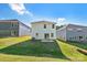 This backyard features a grassy lawn and white siding on the home at 138 Satchel Ct, Mooresville, NC 28115
