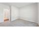 A cozy bedroom with soft carpet, a bright window, and access to an en-suite bathroom at 138 Satchel Ct, Mooresville, NC 28115