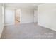 Spacious, carpeted bedroom with access to a private bathroom, featuring ample closet space at 138 Satchel Ct, Mooresville, NC 28115