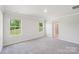This bedroom features two large windows and en suite bathroom at 138 Satchel Ct, Mooresville, NC 28115