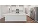 Bright kitchen featuring an island with sink, stainless appliances, and abundant white cabinetry at 138 Satchel Ct, Mooresville, NC 28115