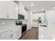 Modern kitchen featuring white cabinets, stainless steel appliances, and stylish marble backsplash at 138 Satchel Ct, Mooresville, NC 28115