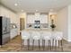 Spacious kitchen island with barstool seating, stainless steel refrigerator, and sleek cabinetry at 138 Satchel Ct, Mooresville, NC 28115