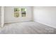 Spacious bedroom with plush carpeting, two windows, and neutral paint, creating a serene atmosphere at 142 Shepherds Landing Dr, Mooresville, NC 28115