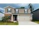 Charming two-story home features a two-car garage, brick accents, and manicured landscaping at 142 Shepherds Landing Dr, Mooresville, NC 28115
