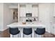 Modern white kitchen with a center island, stainless steel appliances, and bar stool seating at 142 Shepherds Landing Dr, Mooresville, NC 28115