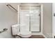 Clean bathroom with a glass-enclosed shower, modern toilet, and convenient towel rack at 16729 Timber Crossing Rd, Charlotte, NC 28213