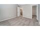 A neutral bedroom with carpeted floors and a view to the staircase at 16729 Timber Crossing Rd, Charlotte, NC 28213