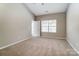 Bright bedroom with neutral carpet, large window, and vaulted ceiling offers a serene living space at 16729 Timber Crossing Rd, Charlotte, NC 28213