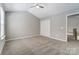 Spacious bedroom features vaulted ceiling, neutral walls, carpet, and closet at 16729 Timber Crossing Rd, Charlotte, NC 28213