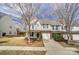 Townhome with light siding, brick facade, a green door, and attached garage at 16729 Timber Crossing Rd, Charlotte, NC 28213