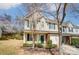 Townhome with light siding, brick facade, a green door, and attached garage at 16729 Timber Crossing Rd, Charlotte, NC 28213