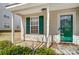 Covered front entrance featuring green door, and green shutters at 16729 Timber Crossing Rd, Charlotte, NC 28213