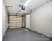 Clean garage with epoxy floor, automatic door opener, and ample space for parking and storage at 16729 Timber Crossing Rd, Charlotte, NC 28213