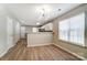 Open concept living room with wood-look floors and modern lighting fixture at 16729 Timber Crossing Rd, Charlotte, NC 28213