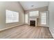 Living room featuring a fireplace with white trim, and patio access at 16729 Timber Crossing Rd, Charlotte, NC 28213