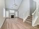 Inviting living room with vaulted ceilings, a fireplace and staircase to the right at 16729 Timber Crossing Rd, Charlotte, NC 28213