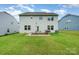 Spacious backyard with a patio, built-in grill, and ample green space, perfect for outdoor entertaining at 16839 Cozy Cove Rd, Charlotte, NC 28278