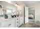 Bathroom featuring a double vanity with black hardware, a large mirror, and access to the main bedroom at 16839 Cozy Cove Rd, Charlotte, NC 28278