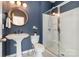 Nicely designed bathroom features a glass-enclosed shower and pedestal sink at 16839 Cozy Cove Rd, Charlotte, NC 28278