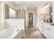 A full bathroom featuring a glass-enclosed shower, soaking tub, and vanity with double sinks at 16839 Cozy Cove Rd, Charlotte, NC 28278