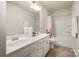 Bathroom with dual sinks, large mirror, tub and shower combo at 16839 Cozy Cove Rd, Charlotte, NC 28278
