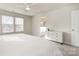 A bright bedroom with a ceiling fan, two windows, and a doorway leading to an attached bathroom at 16839 Cozy Cove Rd, Charlotte, NC 28278