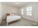 Bright bedroom with two windows and carpeted floors at 16839 Cozy Cove Rd, Charlotte, NC 28278
