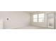 A simple bedroom features a neutral interior with a carpeted floor and large windows at 16839 Cozy Cove Rd, Charlotte, NC 28278