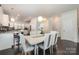 Bright dining area features a modern table set and view into the kitchen at 16839 Cozy Cove Rd, Charlotte, NC 28278