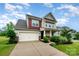 Attractive two-story home with a two-car garage, landscaped front yard, and inviting entryway at 16839 Cozy Cove Rd, Charlotte, NC 28278