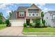 Charming two-story home featuring a two-car garage, a well-manicured lawn, and a welcoming front porch at 16839 Cozy Cove Rd, Charlotte, NC 28278