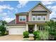 Inviting two-story home boasting a two-car garage, well-kept lawn, and a cozy front porch at 16839 Cozy Cove Rd, Charlotte, NC 28278