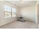 Well-lit home office with a large window and a desk at 16839 Cozy Cove Rd, Charlotte, NC 28278