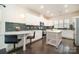 Modern kitchen with white cabinets, breakfast bar, island, and stainless steel appliances at 16839 Cozy Cove Rd, Charlotte, NC 28278