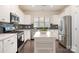 Well-lit kitchen with stainless steel appliances and a movable island at 16839 Cozy Cove Rd, Charlotte, NC 28278