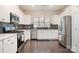 Bright kitchen featuring stainless steel appliances, sleek countertops, and dark backsplash at 16839 Cozy Cove Rd, Charlotte, NC 28278