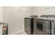 Laundry room featuring modern washer and dryer units with wire rack shelving above at 16839 Cozy Cove Rd, Charlotte, NC 28278