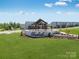 Beautiful landscaped entrance to a residential community with a pergola covered seating area at its center at 1816 Otter Perch Ln, Fort Mill, SC 29715