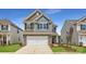 Two-story home featuring stone accents, a two-car garage and neutral color palette at 1816 Otter Perch Ln, Fort Mill, SC 29715