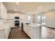 Well-lit kitchen featuring quartz countertops, stainless steel appliances and a spacious island at 1816 Otter Perch Ln, Fort Mill, SC 29715