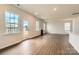 Bright living room with natural light, hardwood floors, and a charming fireplace at 1816 Otter Perch Ln, Fort Mill, SC 29715