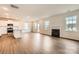 Open-concept living room featuring hardwood floors, recessed lighting, and a modern fireplace at 1816 Otter Perch Ln, Fort Mill, SC 29715